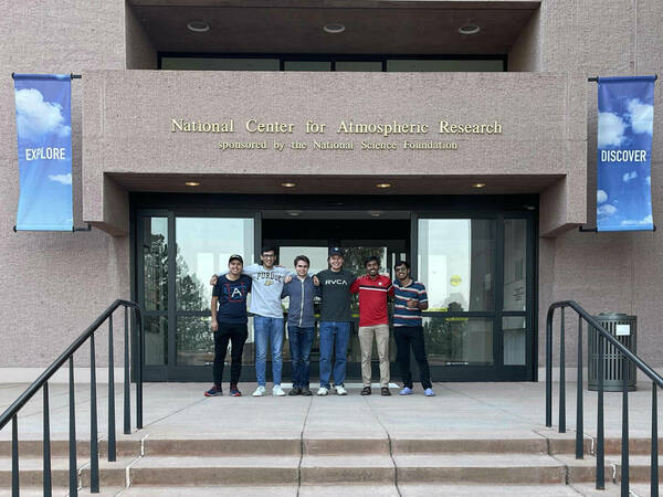 Raja Ali stands with student interns at NCAR during Summer 2023.