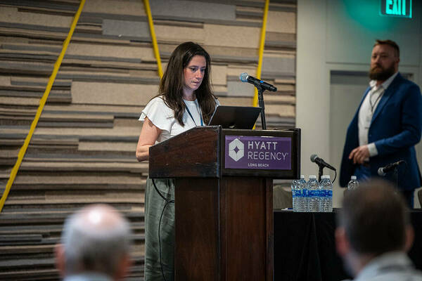 Nicole Virdone, CI Compass project manager and director of outreach, cues up the next lightning talk at CI4MF 2024. Photo/Angie Hubert, NDRC.