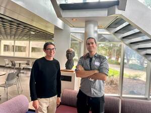 Don Brower and David Butcher stand together in a common area of MagLab.